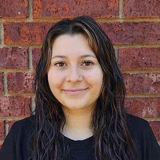 Headshot for Animal Health Care Center's Veterinary Technician Alyssa Veterinary Technician Alyssa with dark wavy hair at Animal Health Care Center
