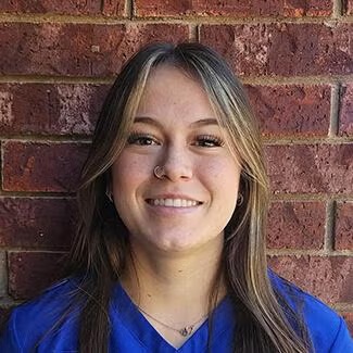 Animal Health Care Center's Veterinary Technician Cassidy Cassidy wearing blue scrubs at Animal Health Care Center